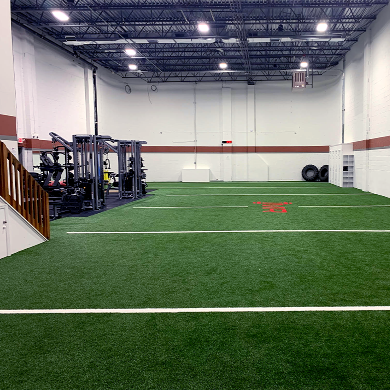 1MR facility with turf field and workout equipment in the background